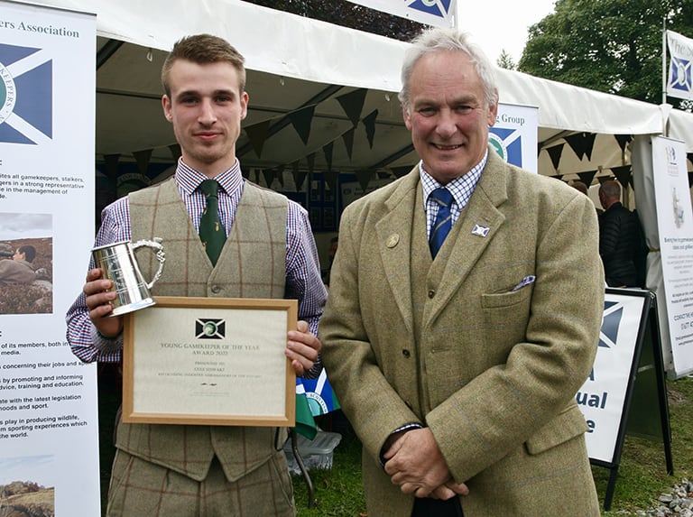 Cole Stewart (left) receiving his Young Gamekeeper of the Year award, 2022, from SGA Chairman Alex Hogg, MBE.