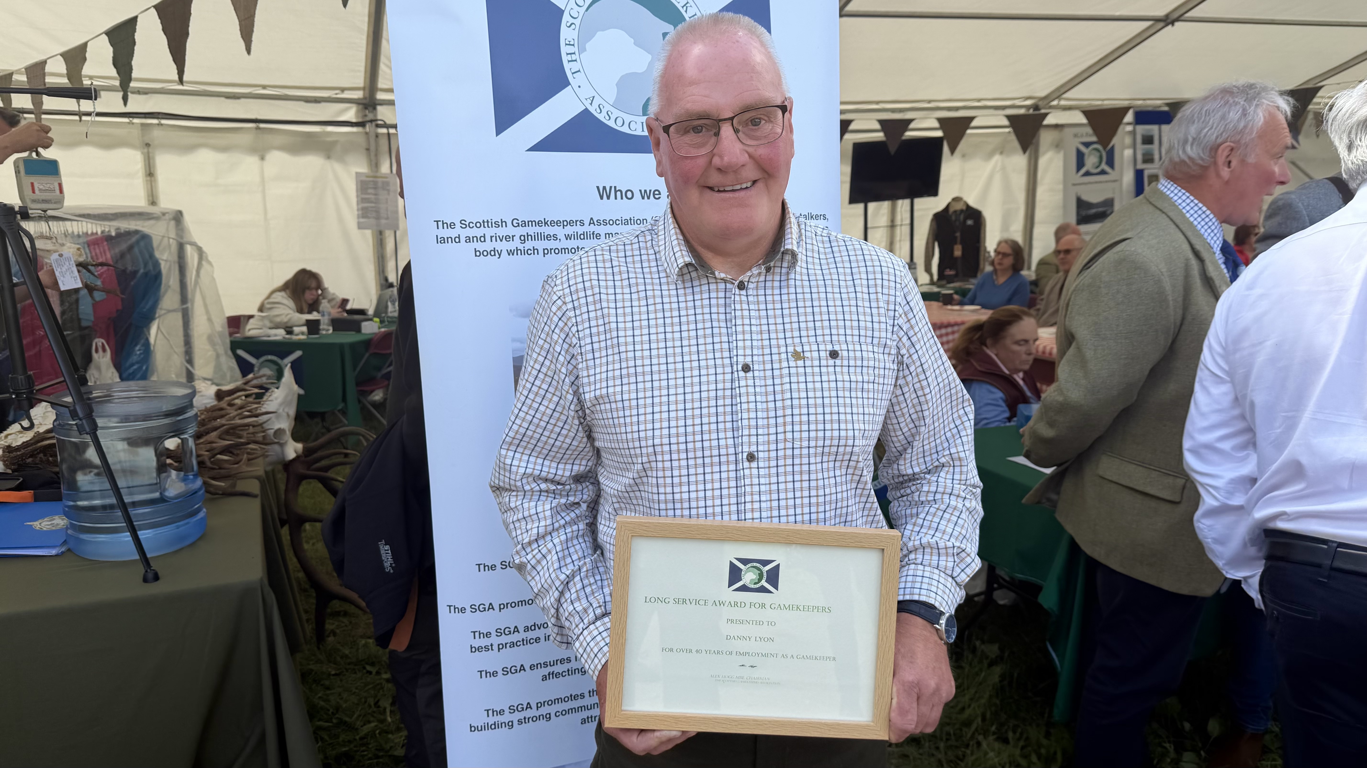 Danny Lyon with his Long Service medal from The Scottish Gamekeepers Association